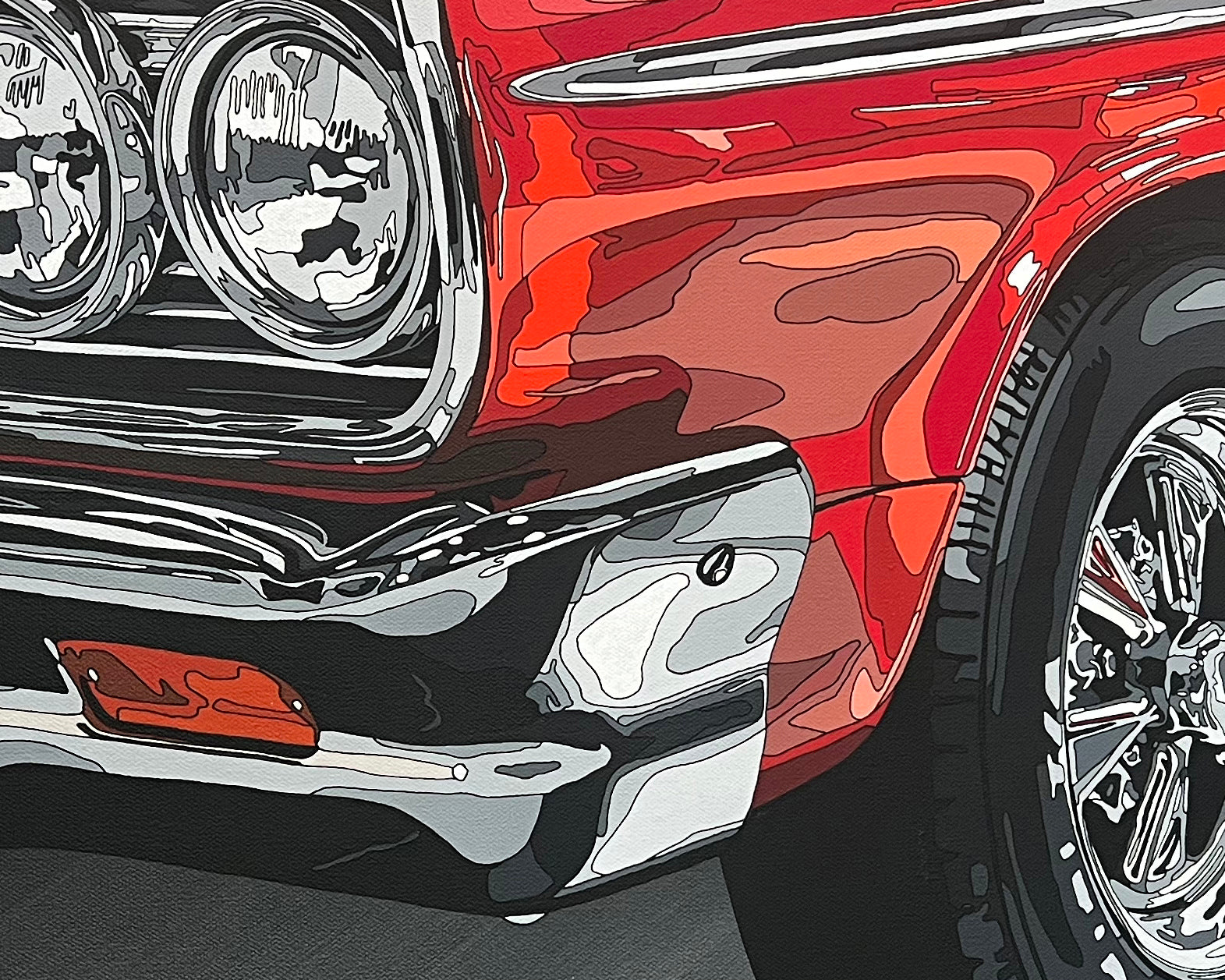 Close-up of a red car's front bumper and tire with chrome details.