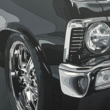 Close-up of a car's front wheel and grille on a dark background