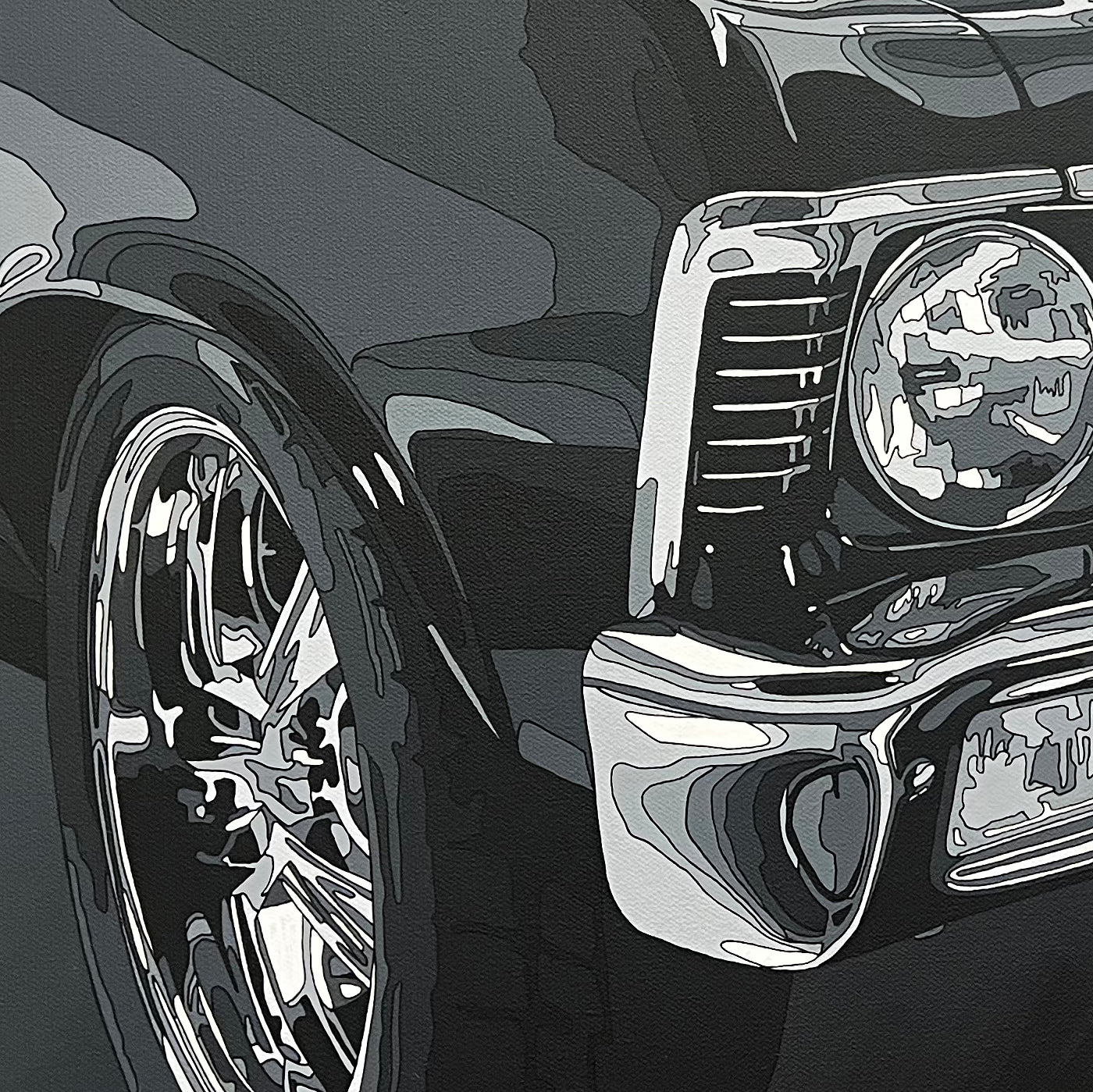 Close-up of a car's front wheel and grille on a dark background