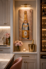 Decorative wall art of a champagne bottle in a kitchen setting with flowers and a champagne bucket.