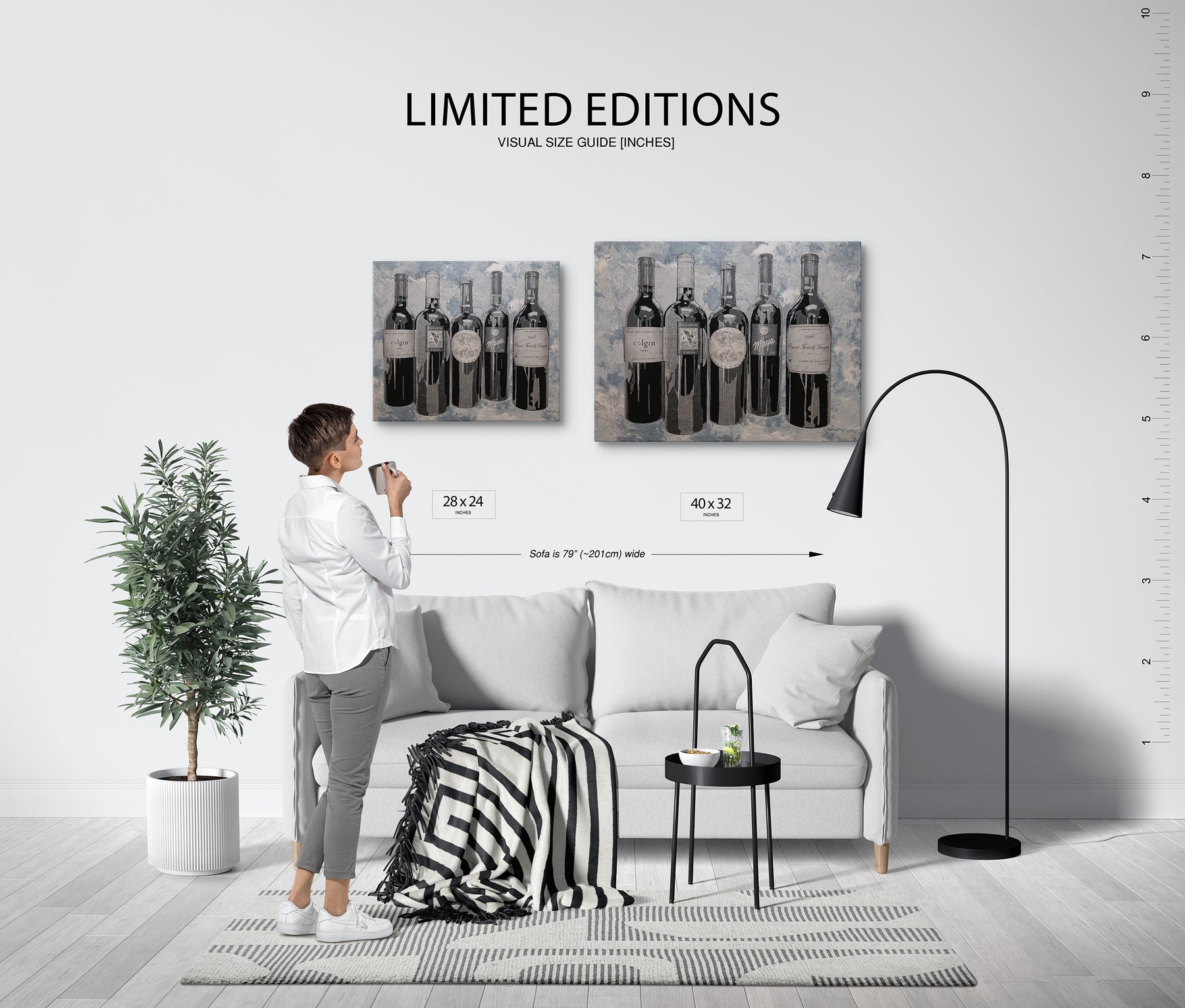 Living room with a person holding a coffee cup, two wall art pieces of wine bottles, and a size guide.