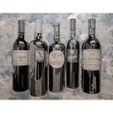Five wine bottles with labels on a textured gray background